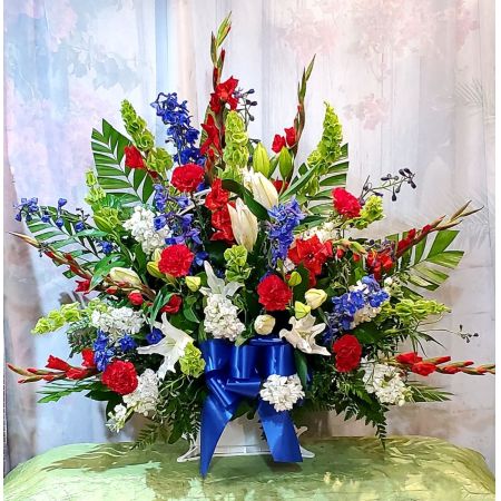 Log Cabin Florist Bakersfield - A BEAUTIFUL RED, WHITE, BLUE SYMPATHY BASKET ARRANGEMENT. **Flowers may vary depending upon availability** (Texas Emblem not available)