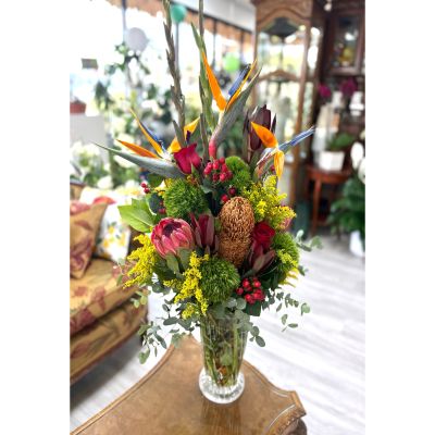 DiBella Flowers & Gifts Las Vegas - Bring a bold, tropical touch to any space with our Exotic Elegance arrangement. Featuring striking Birds of Paradise, lush Proteas, some vibrant red roses, this design bursts with color and texture. This tall, sophisticated arrangement is perfect for making a lasting impression. Ideal for lobbies, events, or as a luxurious gift.