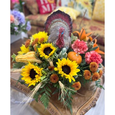 DiBella Flowers & Gifts Las Vegas - “Gobble Me Up” is the ultimate Thanksgiving centerpiece — full of festive charm and autumn color. A cheerful turkey stands proud among golden sunflowers, rustic wheat, and vibrant seasonal blooms, surrounded by touches of gourds and greenery. Perfect for adding a little harvest warmth (and a smile) to your holiday table.