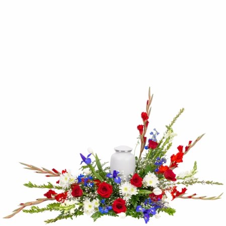 DiBella Flowers & Gifts Las Vegas - Respectful and patriotic, this urn arrangement features fresh red, white, and blue flowers cascading from a base of seasonal greenery. This urn arrangement is designed to make sure the flowers accentuate your loved one's urn, making it a beautiful addition for any service. Medium size pictured here. <b><i>Urn is not included. Make sure your urn does not exceed 12"L x 9"W (any height OK).</i></b>

Medium (as shown) is approximately 36"W x 26"H

<i>This arrangement is custom designed using best-of-day seasonal flowers and may not feature the exact flowers shown. If an item is unavailable, we’ll substitute in products of equal or greater value. Please call us at 702-384-1121 to inquire about our flower selection before placing your order if you require specific flowers be included.</i>