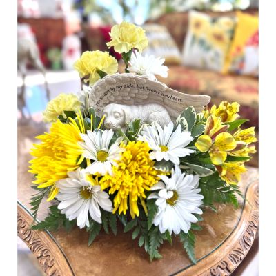 DiBella Flowers & Gifts Las Vegas - This touching memorial arrangement is a beautiful tribute to a beloved pet who has crossed the rainbow bridge. A peaceful dog figurine rests beneath angel wings engraved with the words “No longer by my side, but forever in my heart.” It symbolizes the joy and unconditional love they brought into your life. A comforting and radiant way to honor their memory and keep their spirit close.