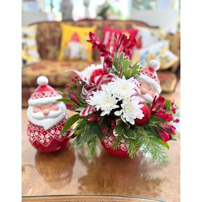 DiBella Flowers & Gifts Las Vegas - Tucked inside a nostalgic Santa cookie jar, this festive arrangement blends merry blooms with wintery greens for a touch of North Pole magic. Santa’s jolly charm pairs with the fresh holiday textures to create a playful, heartwarming piece—perfect for gifting, decorating, or adding a whimsical spark to your Christmas season.
*Includes only 1 Jar*