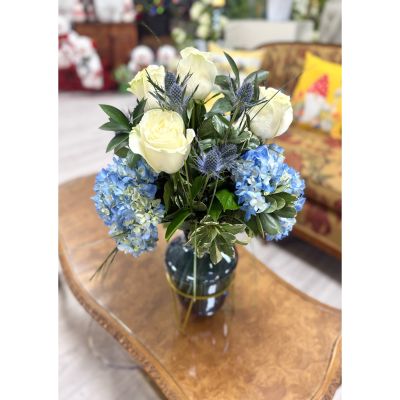 DiBella Flowers & Gifts Las Vegas - Blue Elegance” is a serene Hanukkah arrangement designed to capture the beauty of the season. A graceful blend of icy blues, crisp whites, and silvery accents creates a luminous, peaceful display reminiscent of glowing menorah light. Soft blooms, winter textures, and delicate sparkle come together to honor tradition with a modern, refined touch—perfect for celebrating the Festival of Lights in timeless style.