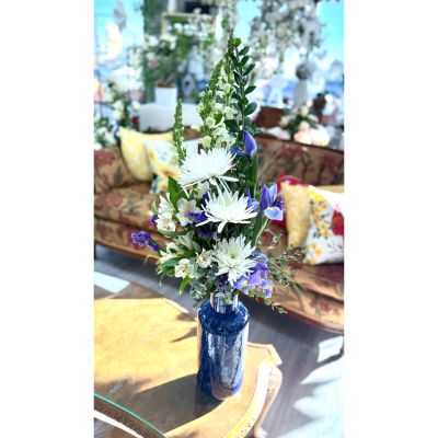 DiBella Flowers & Gifts Las Vegas - Blessings in Blue is an elegant Hanukkah arrangement featuring crisp white blooms, lush greenery, and rich blue accents that symbolize peace and light. Designed in a textured blue vase, its uplifting vertical style adds beauty and meaning to any Hanukkah celebration.