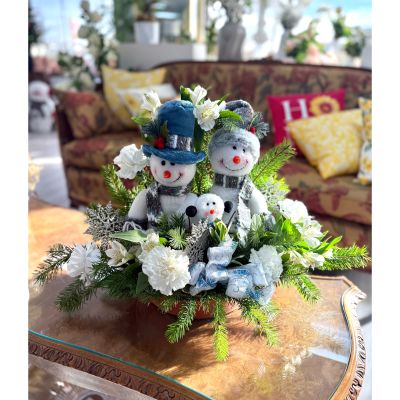 DiBella Flowers & Gifts Las Vegas - Winter Smiles Trio brings cozy holiday cheer with three sweet snowmen nestled among fresh winter greens, crisp white blooms, and festive accents—perfect for spreading warm smiles all season long. 