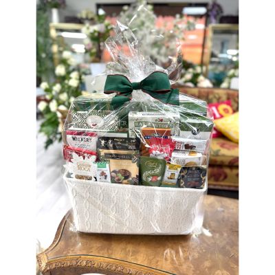DiBella Flowers & Gifts Las Vegas - This cozy goodie basket is filled with a delightful assortment of premium chocolates, cookies, and sweet treats, beautifully wrapped and finished with a classic green bow—perfect for sharing warm holiday moments and indulgent smiles. 