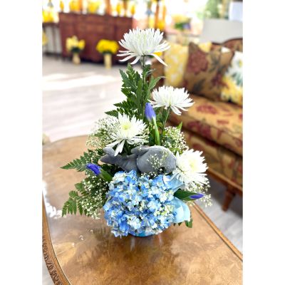 DiBella Flowers & Gifts Las Vegas - Fin-tastic Arrival is a sweet and serene arrangement designed to celebrate a brand-new little one. Soft blue hydrangea, crisp white blooms, and fresh greenery come together in a calming, ocean-inspired palette. Designed among the flowers is an adorable plush whale, adding a playful splash of charm and cuddles. Finished with gentle blue accents, this design is a fin-tastic way to welcome baby with love, joy, and smiles. 