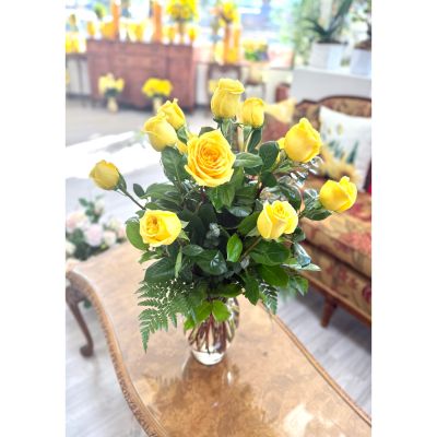 DiBella Flowers & Gifts Las Vegas - A sweet and sunny mix of yellow roses nestled in fresh greenery and arranged in a classic glass vase. This charming bouquet is a joyful twist on romance—perfect for Valentine’s Day or any moment you want to share love, warmth, and a little happiness. 