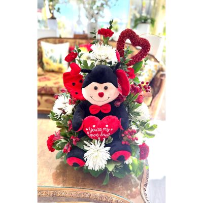 DiBella Flowers & Gifts Las Vegas - Meet Love Bug — an irresistibly sweet arrangement that’s bursting with charm and affection. Nestled in the center is an adorable plush love bug holding a heart that reads “You’re My Love Bug,” surrounded by a cheerful mix of crisp white mums, rich red carnations, and fresh lush greenery. A sparkling red heart accent adds the perfect touch of romance, making this design playful, heartfelt, and full of personality. Perfect for Valentine’s Day or anytime you want to make someone smile and feel extra loved. 