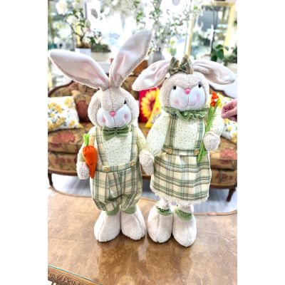 DiBella Flowers & Gifts Las Vegas - Introducing Hazel & Henry, a charming countryside duo full of springtime sweetness.

Hazel is dressed in the prettiest green plaid dress with delicate lace trim and a soft bow nestled between her floppy ears. She carries a slender spring bloom, adding an elegant garden touch to her look. With her rosy cheeks and gentle smile, Hazel brings warmth and grace to any space she’s placed in.

Henry stands proudly beside her in matching green plaid suspenders and a classic bow tie, holding his bright orange carrot like a true little gentleman of the garden. His tall ears and soft expression give him a playful yet timeless charm that feels straight out of a storybook.