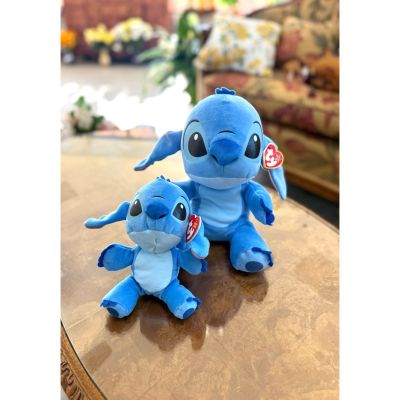 DiBella Flowers & Gifts Las Vegas - These two Stitch Beanie Boos are the sweetest duo, perfectly paired in different sizes. The larger Stitch sits proudly with his wide, sparkling eyes and soft blue plush, ready for big hugs and adventures. Beside him, his smaller counterpart mirrors every adorable detail—from his oversized ears to his tiny stitched smile—just in a more petite, palm-sized form. Both feature the signature Beanie Boo glossy eyes and velvety texture, making them irresistibly cuddly. Together, they create a charming big-and-little set that feels like best friends or siblings, bringing double the cuteness wherever they sit.