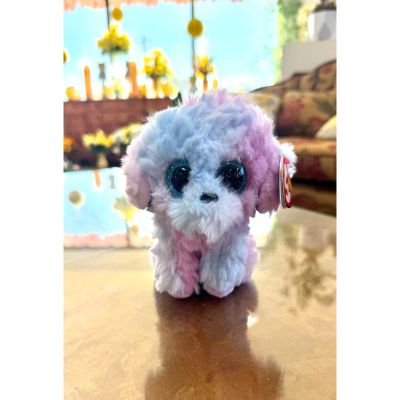 DiBella Flowers & Gifts Las Vegas - Flora is a fluffy dog with soft pastel pink and purple fur and big sparkly eyes. Her colorful, cuddly look makes her extra charming and perfect for snuggles or adding a pop of pastel fun to brighten anyone's day.