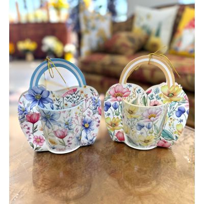 DiBella Flowers & Gifts Las Vegas - Add a touch of charm to any day with these delightful floral mugs, available in your choice of soft blue or sunny yellow. Each mug features a beautiful garden-inspired design filled with delicate blooms, paired with a coordinating decorative holder that makes it feel extra special and gift-ready.

Perfect for Mother’s Day, Administrative Professionals Day, or a thoughtful “just because” surprise, these mugs bring warmth and cheer to every sip. Whether it’s morning coffee or afternoon tea, they’re a sweet way to brighten someone’s routine.