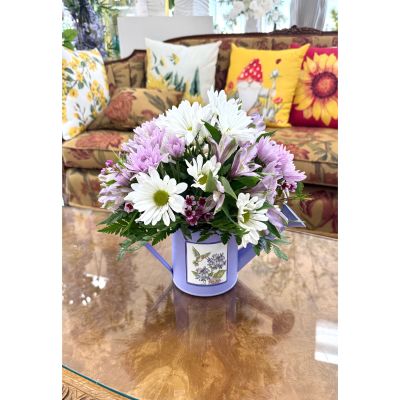 DiBella Flowers & Gifts Las Vegas - Soft and charming, Pouring Petals features delicate white daisies, lavender mums, and light purple accents arranged in a whimsical watering can keepsake. Perfect for birthdays, get well wishes, or everyday moments, it’s a sweet choice for same-day flower delivery Las Vegas and thoughtful last-minute gifts. Handcrafted by dibella flowers and gifts, this design is ideal for anyone searching for pastel flower arrangement Las Vegas same-day delivery with a garden-inspired feel.