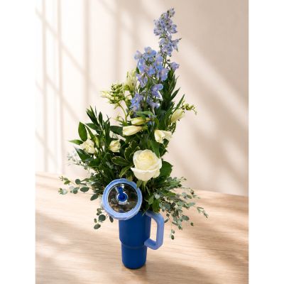 DiBella Flowers & Gifts Las Vegas - Make a lasting impression with The Blue Bloom Bouquet, a stunning floral arrangement designed in a reusable blue handled water bottle. Featuring elegant blue delphinium, classic white roses, lilies, and lush greenery, this fresh design is perfect for birthdays, sympathy, get well wishes, thank you gifts, or simply brightening someone's day. The reusable tumbler makes a practical keepsake long after the flowers have been enjoyed. Flower varieties may vary based on seasonal availability while maintaining the overall color palette and style. Order from DiBella Flowers & Gifts for same-day Las Vegas flower delivery when available.