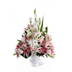 Relles Florist Sacramento - The Precious Peace Arrangement is an exquisite display of serene wishes and grace. Soft pink roses, Peruvian lilies and mini carnations are arranged amongst dazzling Stargazer lilies and white gladiolus, gorgeously accented with lush greens. Perfectly situated in a white plastic designer urn, this stunning arrangement will add to the beauty and elegance of their service or memorial. <br>