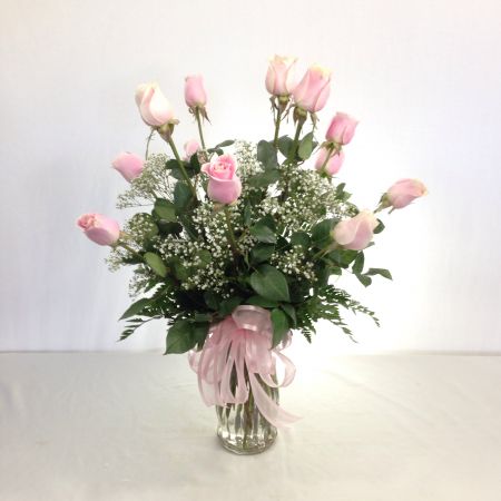 Relles Florist Sacramento - One dozen premium long stem pink roses arranged in a vase with filler.
