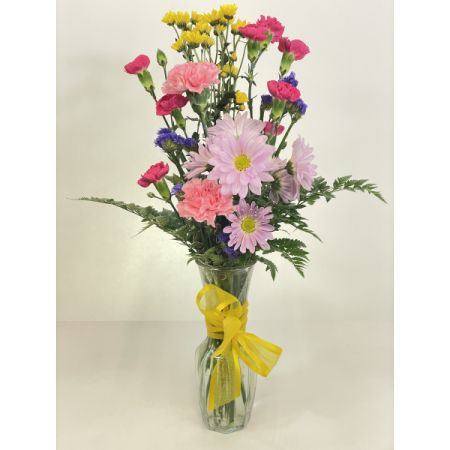 Relles Florist Sacramento - A charming and lively floral arrangement that brings together the playful elegance of chrysanthemum pom pons and the timeless beauty of mini carnations. Meticulously crafted, this bouquet showcases the delightful mix of textures and colors created by these cheerful blooms. With the convenience of same-day delivery, this arrangement ensures a prompt and vibrant surprise, perfect for expressing joy, and gratitude, or sending warm wishes for any occasion. The versatility of chrysanthemum pom pons and the dainty charm of mini carnations make this ensemble suitable for various celebrations. Elevate any space with the fresh and thoughtfully arranged beauty of this diverse and lively floral display.
 Approx 20" h  x 9" w 