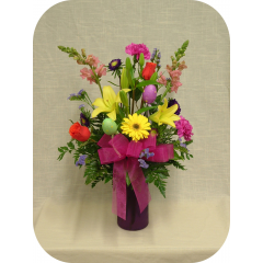 Newtown Floral Company Newtown - Lilies, gerberas, roses, snapdragons, asters, carnations, and statice arranged in an 8" gathering vase with a complimentary pastel color.  Include easter eggs for decor.