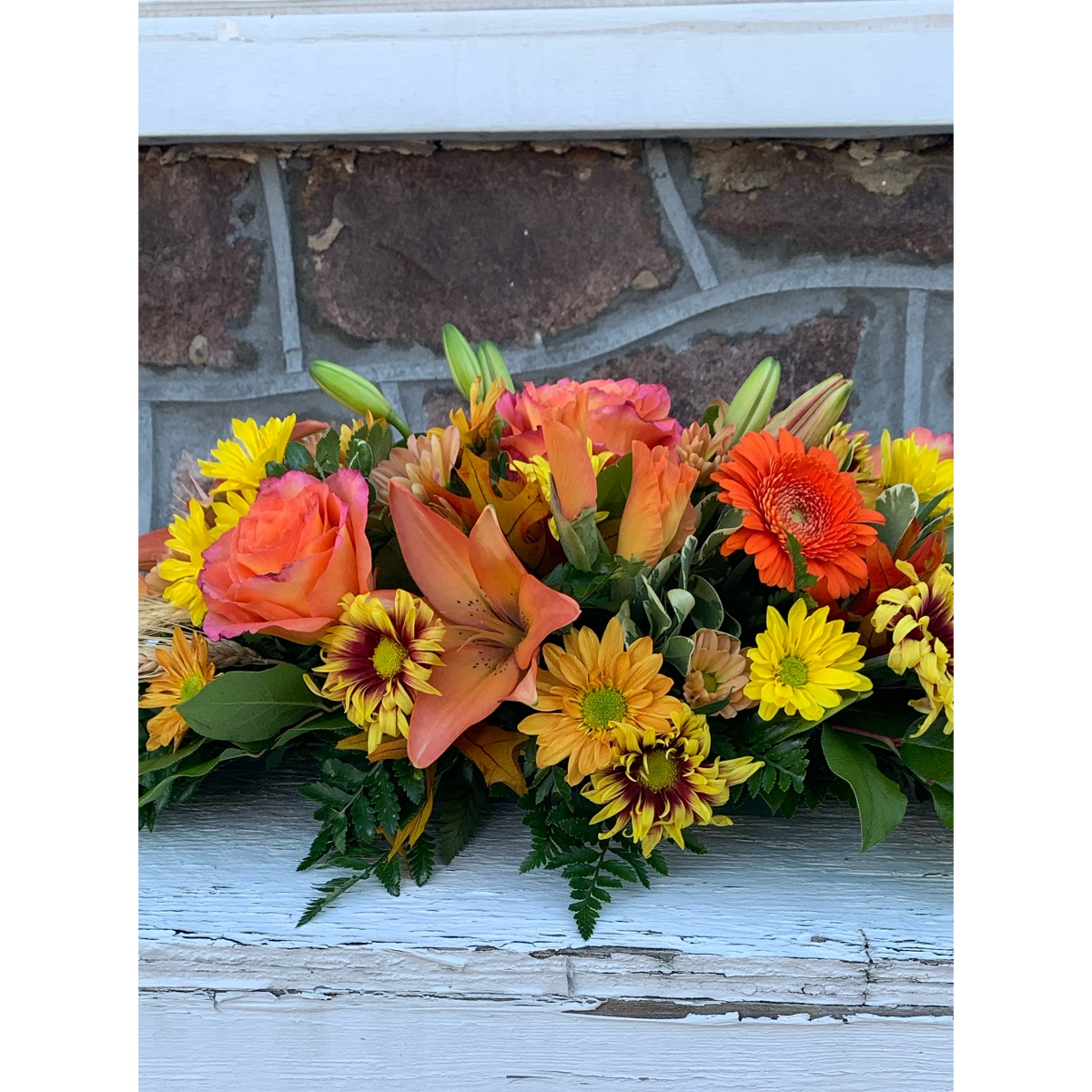 Newtown Floral Company Newtown - Beautiful fall centerpiece perfect for any fall gathering. Flowers will be an abundant fall mixture.