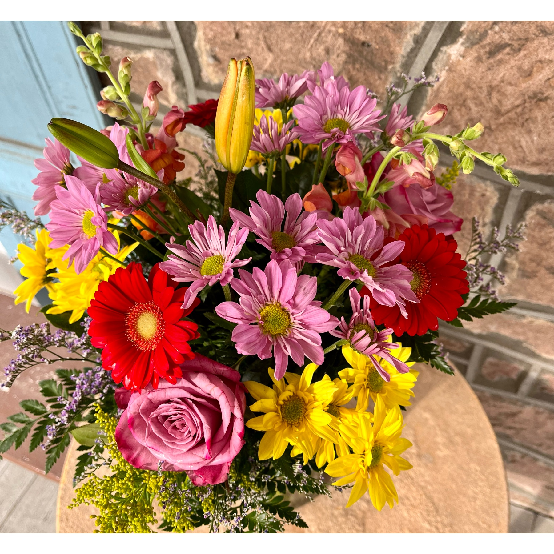 Newtown Floral Company Newtown - Bright colored springy arrangement. Colors may vary slightly but basic color palette will be similar 