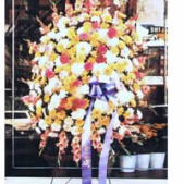 Superior Florist Ltd New York - A floral spray with white, yellow and red.