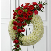 Superior Florist Ltd New York - The Graceful Tribute Wreath is a poignant and elegant arrangement, featuring a white wreath adorned with a generous swag of vibrant red roses, gerberas, and foliage. This arrangement captures the essence of grace and reverence, combining the purity of white with the passionate allure of red blooms. The large swag, meticulously crafted with red roses and gerberas, adds a bold and symbolic touch to the wreath. This creation is a heartfelt tribute that speaks to the beauty of memories and the enduring love for the departed. The Graceful Tribute Wreath serves as a dignified and expressive gesture, offering solace and comfort during moments of reflection and remembrance.





