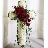Superior Florist Ltd New York - The White Cross with Red Rose Swag is a reverent and beautiful floral arrangement that combines the purity of a white cross with the richness of a red rose swag. The white cross symbolizes faith, purity, and reverence, creating a serene and spiritual atmosphere. Adorned with a swag of red roses, this arrangement adds a touch of love, passion, and remembrance. The red roses, against the backdrop of the white cross, create a visually stunning and meaningful display. The White Cross with Red Rose Swag serves as a powerful and elegant expression of condolences, offering comfort and warmth during moments of grief while honoring the memory of a loved one with grace and beauty.