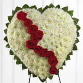 Superior Florist Ltd New York - The Broken White Heart on an easel is a poignant and symbolic arrangement designed to express the emotions of loss and remembrance. Crafted in the shape of a broken heart, this arrangement represents the grief and sorrow felt during moments of mourning. The use of white blooms symbolizes purity, peace, and the hope for eternal rest. Displayed on an easel, this arrangement stands as a visual tribute, offering a dignified and heartfelt expression of condolences. The Broken White Heart serves as a powerful representation of the enduring love and memories shared with the departed, providing a fitting and compassionate tribute during times of sorrow.