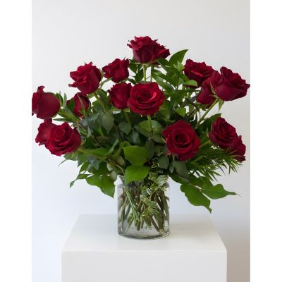 Uptown Blossoms Anchorage - Make a statement with the Uptown Modern 2 Dozen Roses – a luxurious bouquet of velvety, deep red roses, brimming with romance and passion. These stunning long-stemmed roses are expertly arranged with delicate greenery, creating a sophisticated and contemporary display. Perfect for expressing profound love, celebrating a special occasion, or simply bringing a touch of timeless elegance into your home.  Send the ultimate gesture of affection with this breathtaking arrangement of fresh red roses today! Other colors available.