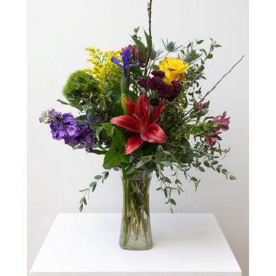 Uptown Blossoms Anchorage - Embrace free-spirited beauty with our 'Bohemian Style Vase', a captivating blend of textures and hues.
Delicate irises, soft roses, and cheerful lilies dance amongst vibrant wildflowers and lush greenery in a uniquely shaped glass vessel.
This stunning floral arrangement fills any space with a relaxed, artistic vibe – perfect for adding a touch of nature to your home or gifting a moment of joyful serenity. 
Send a little wildflower magic with this beautiful, handcrafted bouquet, ideal for birthdays, celebrations, or simply ‘just because’.