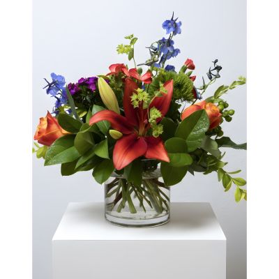 Uptown Blossoms Anchorage - The 'Uptown Vase' is a burst of joyful color, featuring vibrant mums, irises, and lilies dancing amongst lush greenery. 
A captivating blend of purple, orange, and green creates a stunning centerpiece perfect for brightening any room or celebrating a special occasion.
Send a touch of sophisticated cheer with this exquisite **flower arrangement**, ideal for birthdays, thank you gifts, or simply to show someone you care.
This **fresh flower bouquet** delivers a moment of pure beauty and fragrant delight, hand-arranged with love and delivered fresh to their door.