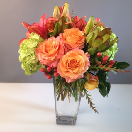 Boulder City Florist Boulder City - Roses with complimenting bright colored flowers  Bright and flirty. Container and flowers subject to availability. 