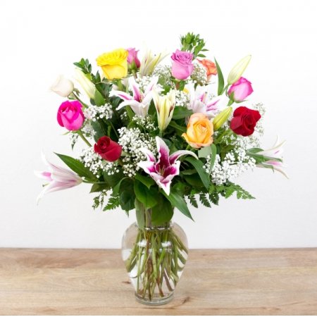 Boulder City Florist Boulder City - Our 'Timeless Jewel" melds the beautiful elegance of premium long-stem color roses with a beautiful, fragrant stargazer lilies in pinks and whites, all accented with seasonal greenery in a traditional glass vase. This is one of our most popular pieces and a perfect choice to express your love and affection. <i>Rose colors and varieties will vary based on seasonal availability</i>

Arrangement (1 doz) is approximately 24"H x 20"W and includes 10 mixed color roses, 2 red roses, and 4 stems of lilies
<!--<i>Select our 2 Dozen or 3 Dozen for a bigger presentation.</i><br/>-->