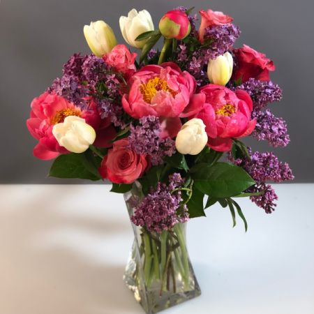 Bouquets Denver - International springy blossoms! Alaskan peonies accented with Ecuadorian Tea Roses, California Tulips, and Peruvian Statice. 