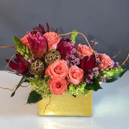 Bouquets Denver - Introducing "The Gold and the Beautiful," a stunning arrangement for those who adore gold and beautiful colors. This vibrant mix includes colored roses, flowing Curly willow, and eye-catching gold knitted ball accents. The arrangement is presented in a gorgeous metallic finish container that measures 8.5" long, making it a show-stopping centerpiece for a coffee table, mantle, or kitchen island. The oblong and sleek design adds a touch of sophistication, making it an ideal and thoughtful gift for someone special. Enjoy the convenience of same-day flower delivery, ensuring this dazzling display promptly elevates any space. Embrace the luxurious and lively atmosphere created by "The Gold and the Beautiful," a perfect expression of style and elegance.






