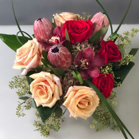 Bouquets Denver - Capture the essence of romance with a stunning arrangement of muted-toned roses, complemented by vibrant red romantic roses. Hydrangeas and beautiful foliage accents add a touch of timeless elegance to this floral composition. Enjoy the convenience of same-day flower delivery, ensuring your romantic gesture is delivered promptly. Elevate the ambiance with the soft hues and delicate textures of this thoughtfully curated bouquet. Bring an air of sophistication to any occasion with this captivating blend of flowers and foliage. Celebrate love and beauty with this enchanting arrangement that speaks volumes in its muted and romantic tones.






