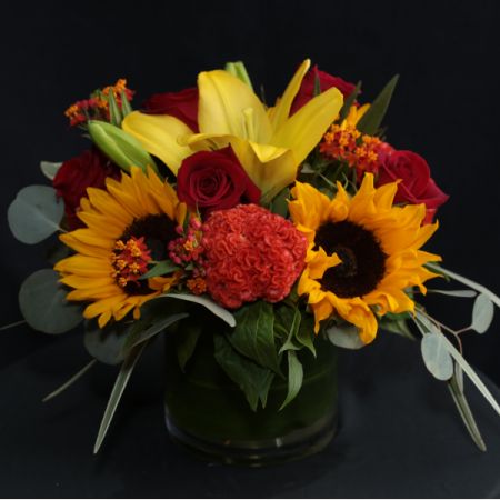 Ninth Street Flowers Durham - A tight, European style arrangement featuring sunflowers, roses and celosia